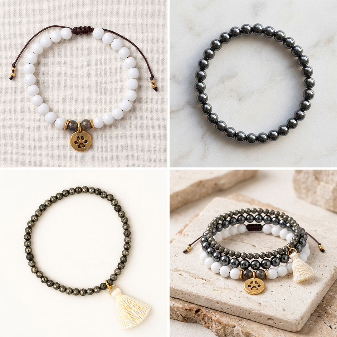 Four-image collage showing a handcrafted gemstone bracelet trio: white jade and labradorite with a gold-plated paw charm, polished hematite, and pyrite with a cream tassel, displayed individually and stacked on a stone surface.