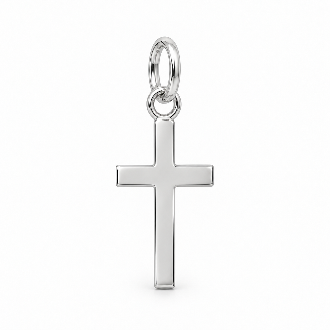 A polished silver cross pendant with a flat, rectangular design and a jumpring bail, shown against a plain white background.