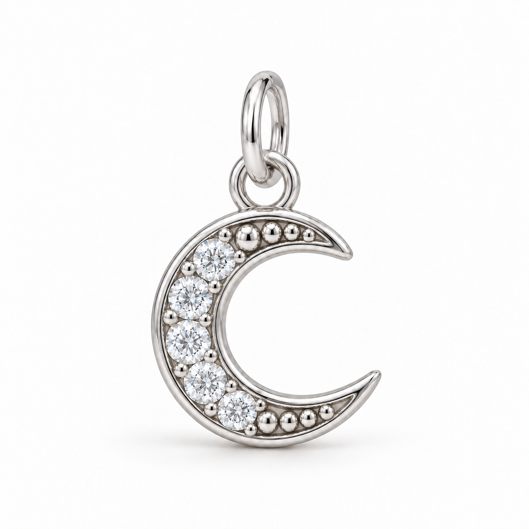 A silver crescent moon pendant charm adorned with clear round-cut cubic zirconia stones, shown on a clean white background.