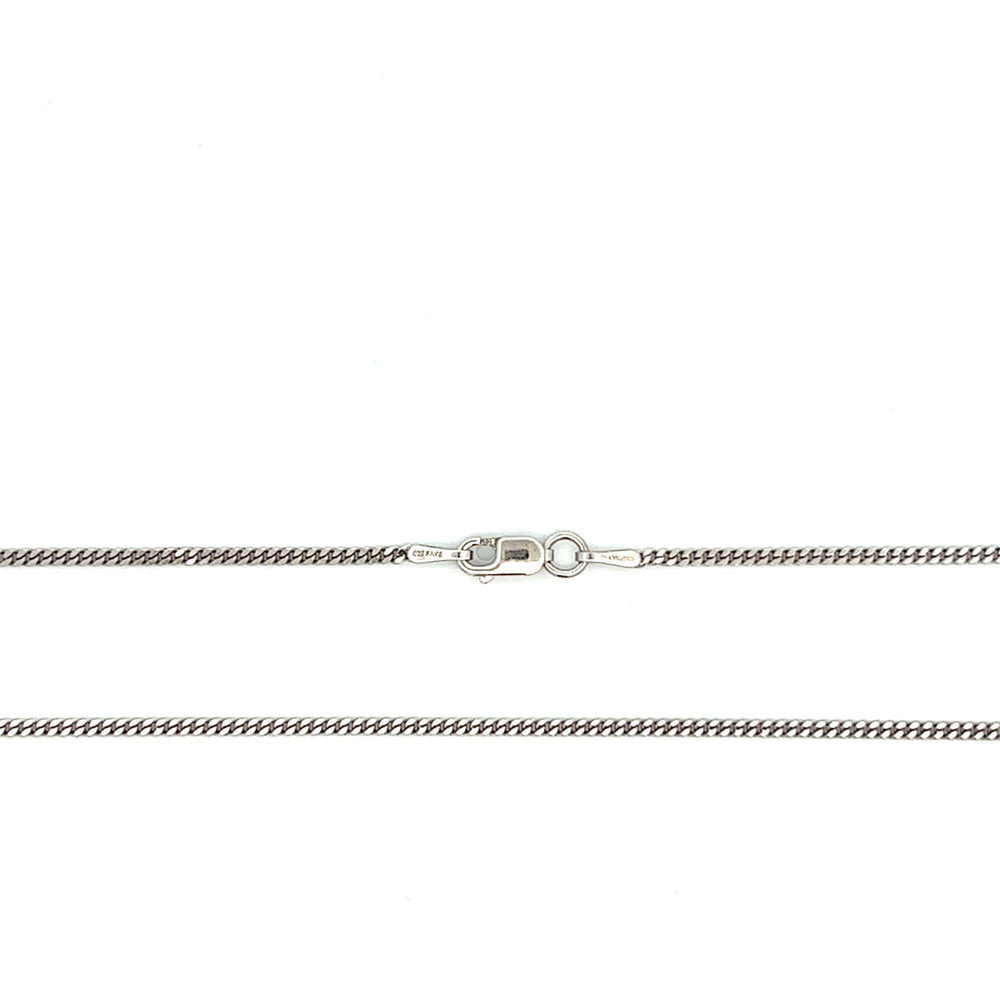 Close-up of fine 1.5 mm sterling silver curb chain with antiqued rhodium plating and a lobster clasp.