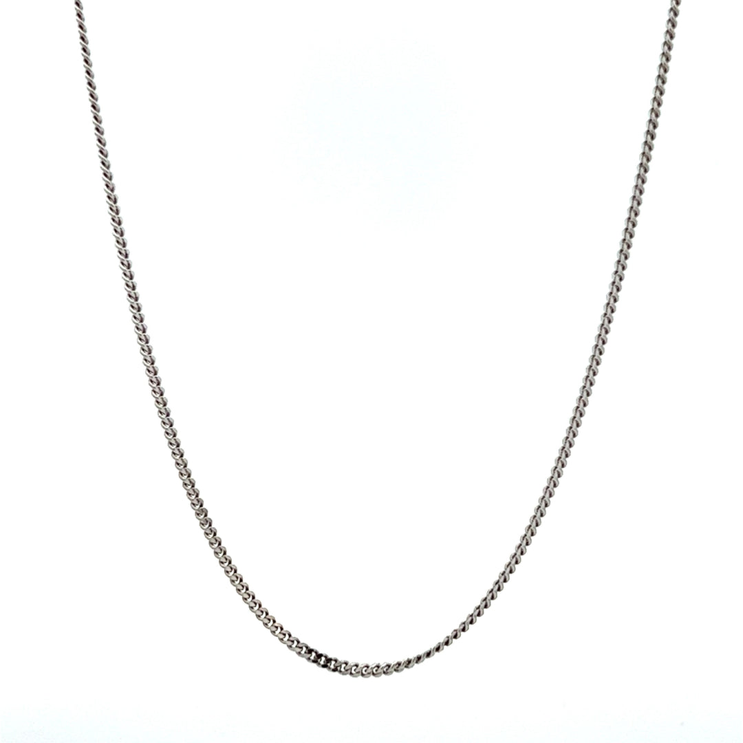 A rhodium plated sterling silver curb chain necklace laid out on a plain background.